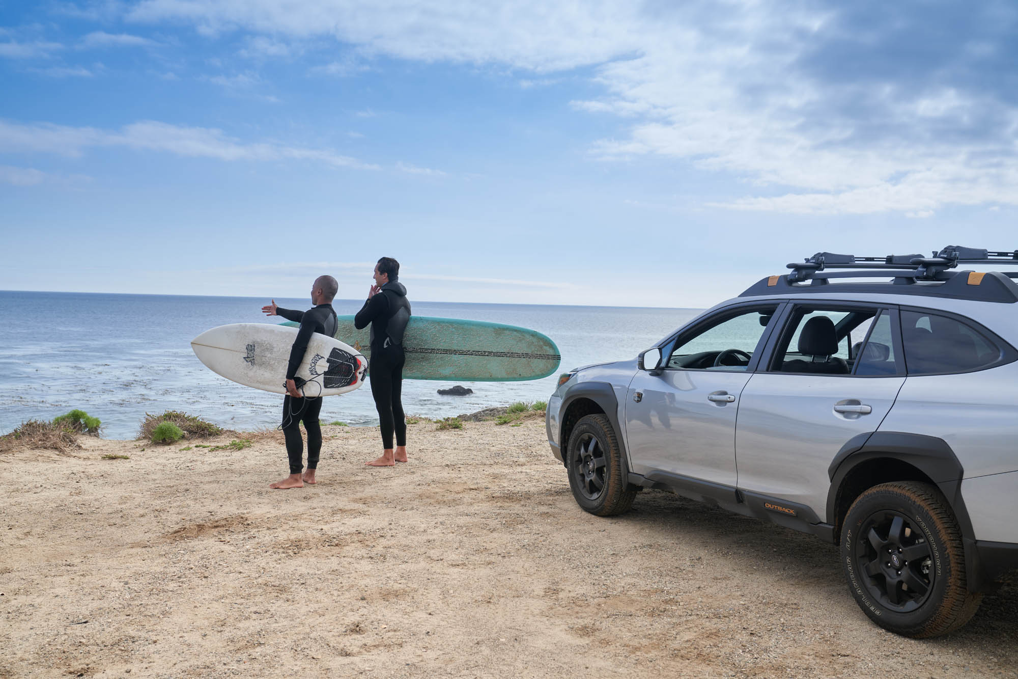 Surfers and Subaru Outback at Beach